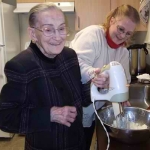 Staff members (Julie, pictured) helped Senior Independence Hospice client Francis (at left) bake cupcakes on her birthday.